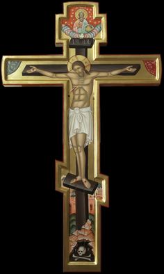 a crucifix with the image of jesus on it's cross in gold and black