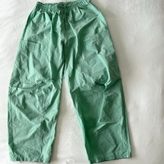 These Super Trendy Uo Pant Don't Have Tags But Have Never Been Used!!!!! - Wide Leg - Baggy - Green Color Has A Slight Shimmer In The Sunlight - Adjustable Drawstring Waistband - Nylon Fabric - 2 Pockets Urban Outfitters Casual Relaxed Fit Pants, Green Stretch Parachute Pants With Pockets, Stretch Green Parachute Pants With Pockets, Green Parachute Pants With Elastic Waistband, Relaxed Fit, High Waist Green Parachute Pants With Elastic Waistband, Green Relaxed Fit Parachute Pants With Elastic Waistband, Green Parachute Pants With Relaxed Fit And Elastic Waistband, Green Relaxed Fit Parachute Pants For Summer, Green Parachute Pants For Spring Loungewear