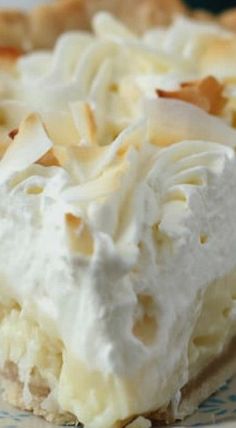 a piece of pie with white frosting on a blue and white plate next to a fork