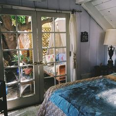 a bed sitting under a window next to a door