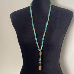 Glass Turquoise Beaded Necklace With Brass Buddha Charm Handmade Jewelry By Me Turquoise Beaded Necklace For The Beach, Turquoise Long Beaded Necklace For Beach, Turquoise Beaded Necklaces For Healing, Beaded Turquoise Necklace For Beach, Adjustable Beaded Long Turquoise Necklace, Gold Beaded Turquoise Necklace For Beach, Turquoise Long Beaded Chain Necklace, Elegant Beaded Turquoise Necklace For Beach, Hand-strung Turquoise Necklace For Beach