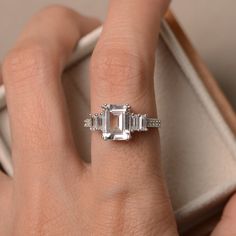 This ring features a 7*9mm white topaz and sterling silver finished with rhodium. Customization is available. It is made by hand, and it will take about 7 days to finish the ring after your payment is completed. Any question, just let me know. :) My shop homepage: https://www.etsy.com/shop/LuoJewelry?ref=l2-shopheader-name White Topaz Engagement Ring, Topaz Engagement Ring, Ring Promise, Topaz Ring, Ring Sterling Silver, White Topaz, Promise Ring, Sterling Ring, Emerald Cut