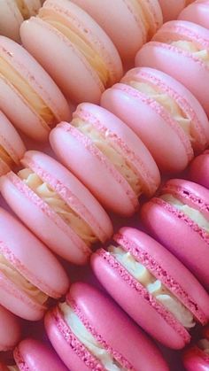 pink and white macaroons are lined up together