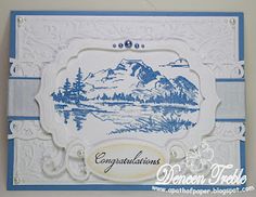 a blue and white card with an image of a mountain range in the background that says congratulations