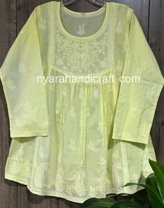 Pure cotton Chikankari hand embroidered a line blouse. Length: 30 inches Luxury Chikankari Embroidery Top For Party, Spring Anarkali Long Sleeve Tops, Spring Anarkali Top With Long Sleeves, Spring Cotton Kurta With Motifs, Yellow Chikankari Embroidered Festive Top, Cotton Straight Kurta With Chikankari Embroidery, Cotton Kurta With Yoke For Navratri, Navratri Cotton Kurta With Yoke Detail, Yellow Long Sleeve Top With Chikankari Embroidery