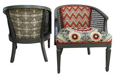 two chairs with patterned cushions on them, one is black and the other is red