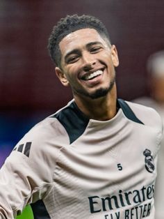 a soccer player is smiling and looking at the camera