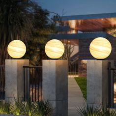 three lights are on top of cement pillars