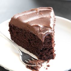 a piece of chocolate cake on a plate with a fork