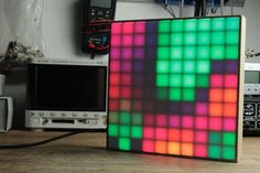 a computer monitor sitting on top of a wooden table