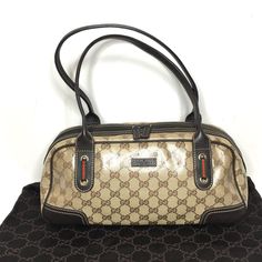 Authentic Gucci Princy Bag. Made In Italy. Monogram Glossy Very Durable Coated Canvas With Brown Leather Trims And Handles. Signage Red And Green Ribbon Accents. Very Good Condition. Canvas In Very Good Condition, One Small Pink Stain. Handles Are Strong, The Bag Fits Comfortably On A Shoulder. Pet & Smoke Free Environment, No Odor. Protective Metal Legs On The Bottom. Zipper Works Properly. Dark Lining Inside. One Side Zipper Pocket Inside. Dust Bag Included. Classic And Timeless Gucci Princy B Pre-owned Business Bags, Pre-owned Gucci Leather Shoulder Bag, Green Ribbon, Leather Trims, Gucci Bag, Inside Pocket, Side Zipper, Zipper Pocket, Bags Handbags