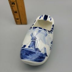 a pair of blue and white shoes next to a ruler