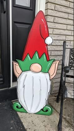 an inflatable garden gnome is sitting on the front door steps with his hat on