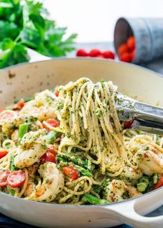 pasta with shrimp and pesto in a white bowl