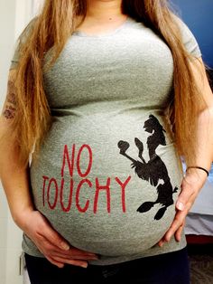 a pregnant woman holding her belly with the words no to ugly written on it