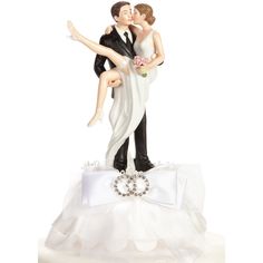 a wedding cake topper with a bride and groom holding each other in their arms