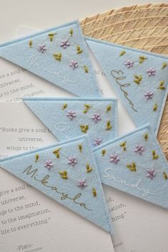 three blue and gold wedding cards with flowers on them are laying next to each other