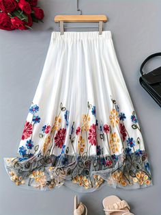 White Embroidered Full Skirt, Spring Embroidered Skirted Bottoms, Embroidered Skirted Bottoms For Spring, White Floral Embroidered Tiered Skirt, Floral Embroidered Full Skirt For Spring, Floral Embroidered Full Skirt Bottoms, Floral Embroidered Flowy Skirt, Spring Full Skirt With Floral Embroidery, White Embroidered Tiered Skirt