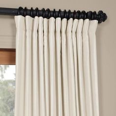 white curtains hanging on the side of a window