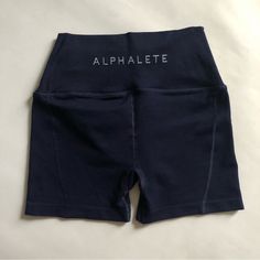 Alphalete High Rise Revival Shorts, Size Small. Navy Blue. New Condition, Never Worn. Squat Proof. Activewear / Gym Wear, Also Cute Worn Casually. Tag Size - Small Brand - Alphalete Condition - Brand New Waist 12” Inseam 4” #Alphalete #Shorts #Small #Revival #Highrise Blue Stretch Activewear With Letter Print, Blue Workout Activewear With Letter Print, Blue Letter Print Activewear For Summer, High Waist Blue Training Shorts, High Waisted Blue Shorts For Training, High Waist Blue Shorts For Training, Blue Bottoms With Letter Print, Short Length, Fitted Blue Bottoms With Letter Print, Blue Letter Print Shorts