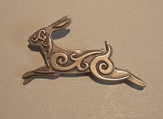 a metal brooch with an animal design on it