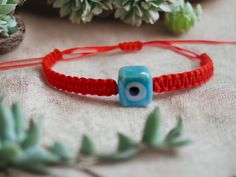 It is rumored that the evil eye bead has been protecting from bad energies since ancient times. For this reason, it has been used as a protective jewelry for centuries. Red cord bracelets are thought to bring luck according to Tibe Buddhist belief. We combined the protective evil eye bead with lucky red string Kabbalah Bracelets. We used evil eye beads in the form of ceramic cubes on our bracelets. It is the cube ceramic evil eye bead that distinguishes this model from ordinary evil eye bracelet Handmade Red Evil Eye Bracelet As A Gift, Red Evil Eye Braided Bracelet Gift, Handmade Red Evil Eye Bracelet For Good Luck, Red Resizable Evil Eye Spiritual Bracelet, Buddhist Beliefs, Adjustable Red Evil Eye Bracelet, Hand-strung, Kabbalah Bracelet, Evil Eye Bracelet, Cord Bracelets