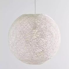 a white ball hanging from a string light fixture with strings attached to the top and bottom