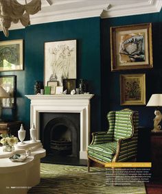 a living room filled with furniture and pictures on the wall above a fire place in front of a fireplace