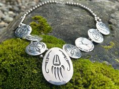 This necklace was made by Willie Yazzie (1937-2009). He was a Navajo artist who specialized in squash blossom style storyteller necklaces made of sterling silver. The 9 discs of this necklace represent traditional Navajo symbols of a bear paw claw, thunderbird, antelope (unsure), and roadrunner. The necklace is unstamped and was sterling silver tested. There is a hallmark of a gourd medicine dipper, which was Willie Yazzie's signature mark.  Total weight 184.4 grams, measuring 25 3/4 inches long.  Everything is shipped with signature requirement for the safety of your purchase! Squash Blossom, Bear Paws, Wedding Jewellery Necklace, Wedding Necklace, Storytelling, Wedding Jewelry, Necklace Etsy, Jewelry Necklaces, Accessory Gift