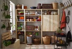 an organized kitchen with lots of pots and pans on the shelves next to each other