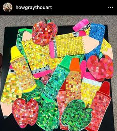 a table topped with lots of different colored pieces of glass mosaics and apple slices