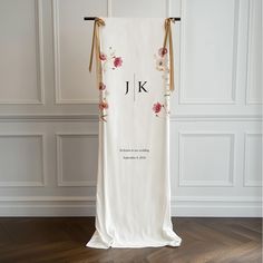 the back of a wedding dress hanging on a hanger in front of a wall