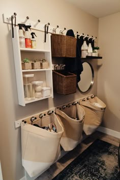 a bathroom with several storage bins on the wall