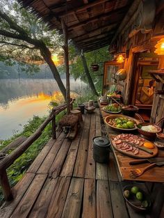 a wooden deck with food on it next to water