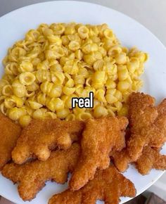 a white plate topped with fried chicken and macaroni