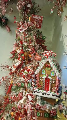 a christmas tree decorated with gingerbreads, candy canes and other holiday decorations