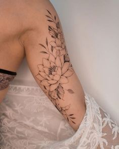 a woman's arm with a flower tattoo on the left side of her body