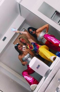 two women in colorful outfits are taking a selfie