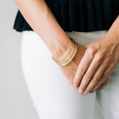 Model wearing multiple Yearly Co. Original bangles on her wrist.