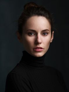 a woman in black is posing for a photo