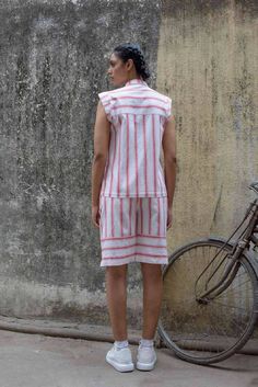 Description: Crisp and light, handwoven cotton. In candy red stripes, this shirt has an easy cut with a front & back yoke. Gathers into front yoke. Mandarin collar and exaggerated shoulders. Buttoned down.Colour: Red/WhiteFabric: Handwoven CottonProduct Details: 100% Cotton Made in IndiaGarment length XS - 25"Garment length S - 25"Garment length M - 25"Garment length L - 25.5"Garment length XL - 26"Size and Fit: Height: 5.8 ftModel is wearing size SFit: RelaxedProduct Care: Gentle hand wash sepa Slow Clothing, Thought Clothing, Mandarin Collar Shirt, Candy Red, White Product, Red Candy, Liquid Detergent, Drip Dry, Colour Red