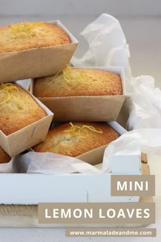 a bunch of lemon muffins sitting on top of a wooden tray