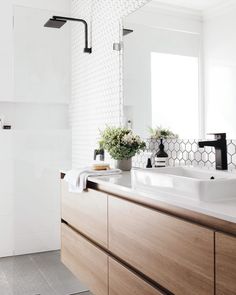 a bathroom with two sinks and a large mirror