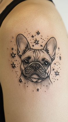 a black and white tattoo of a dog with stars on it's back shoulder