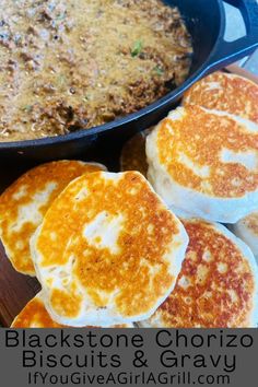 some food that is in a pan and on a wooden board with the words blackstone chorizzo biscuits & gravy