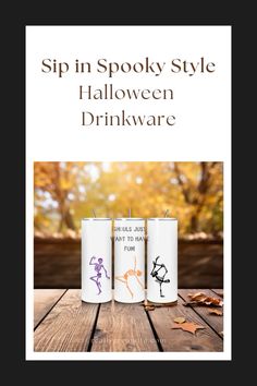 three spooky style halloween drinkware on a wooden table with autumn leaves in the background