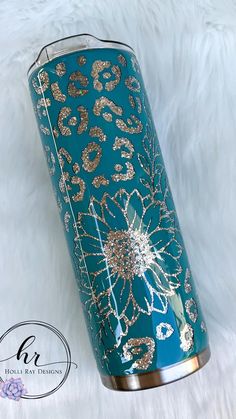 a blue and gold travel mug on white fur