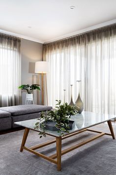 a living room with two couches and a coffee table in front of the window