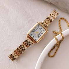 Enhance your elegance with this luxurious gold-plated women's watch featuring a sleek rectangular dial adorned with classic Roman numerals. Perfect for any occasion, this timeless piece combines vintage charm with modern sophistication. The high-quality craftsmanship ensures durability while the adjustable gold link bracelet provides a comfortable fit. Whether as a treat for yourself or a gift for a loved one, this watch is a statement of refined style and grace. Technical specifications: ➡ Move Classic Gold Watch With Square Face, Minimalist Square-faced Quartz Watch, Minimalist Square Face Quartz Watch, Elegant Gold Square-faced Watch, Elegant Gold Square Face Watch, Elegant Yellow Gold Rectangular Watch, Classic Metal Watch With Rectangular Dial, Classic Watch With Rectangular Metal Dial, Gold Watches With Bracelet Strap And Rectangular Dial