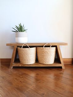 two baskets sit on top of a wooden shelf